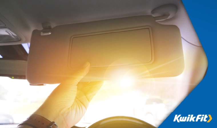 sun visor lowered to avoid the low sun